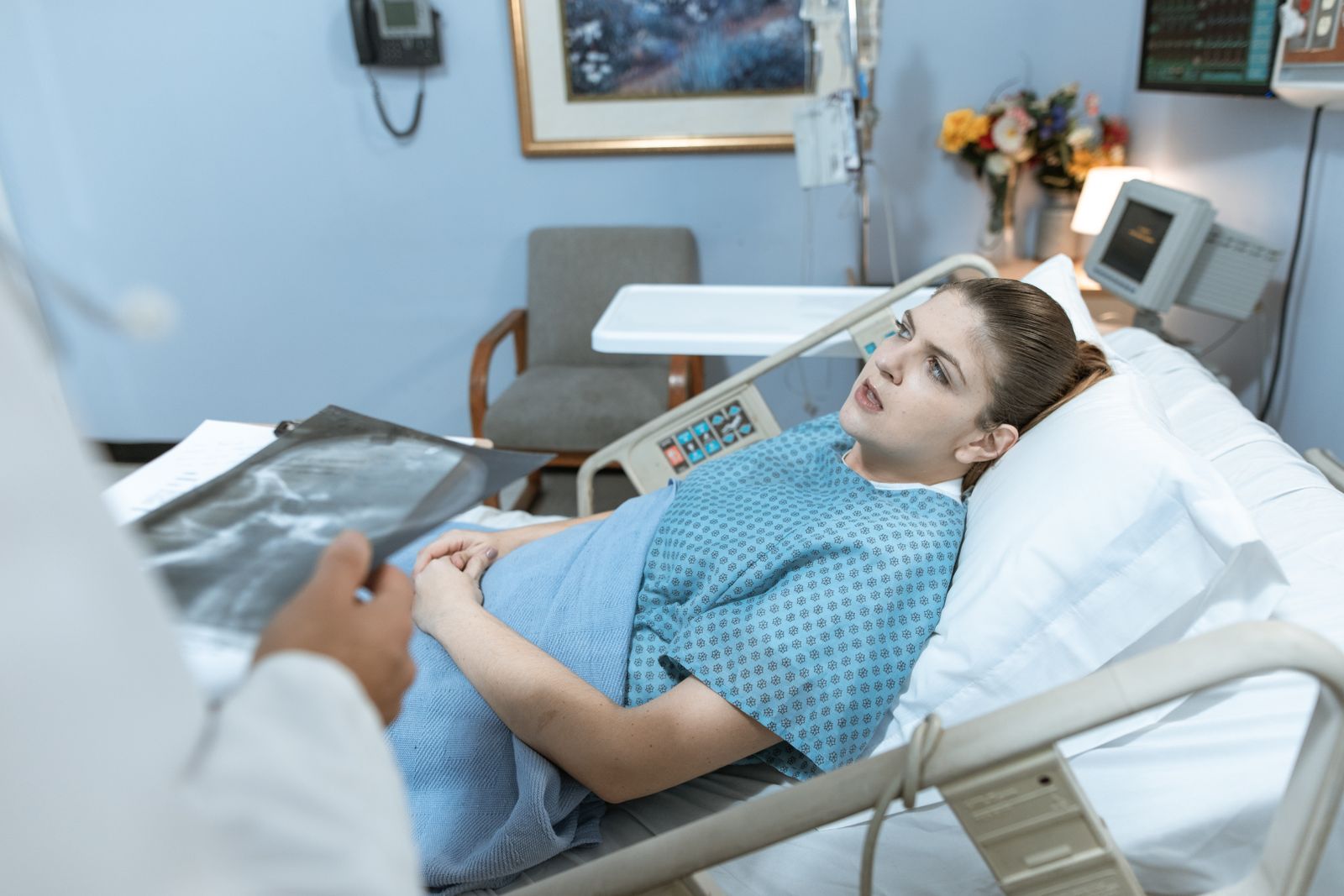 Patient resting in a hospital bed while receiving medical care