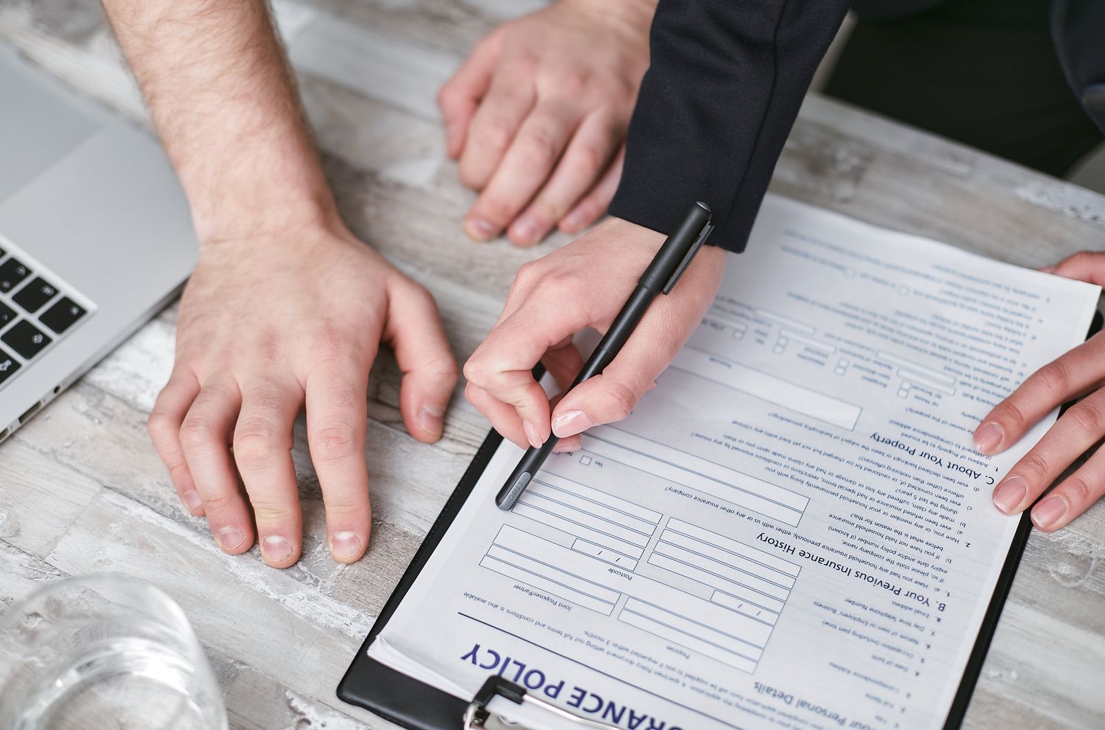 Person reviewing and signing an insurance policy document