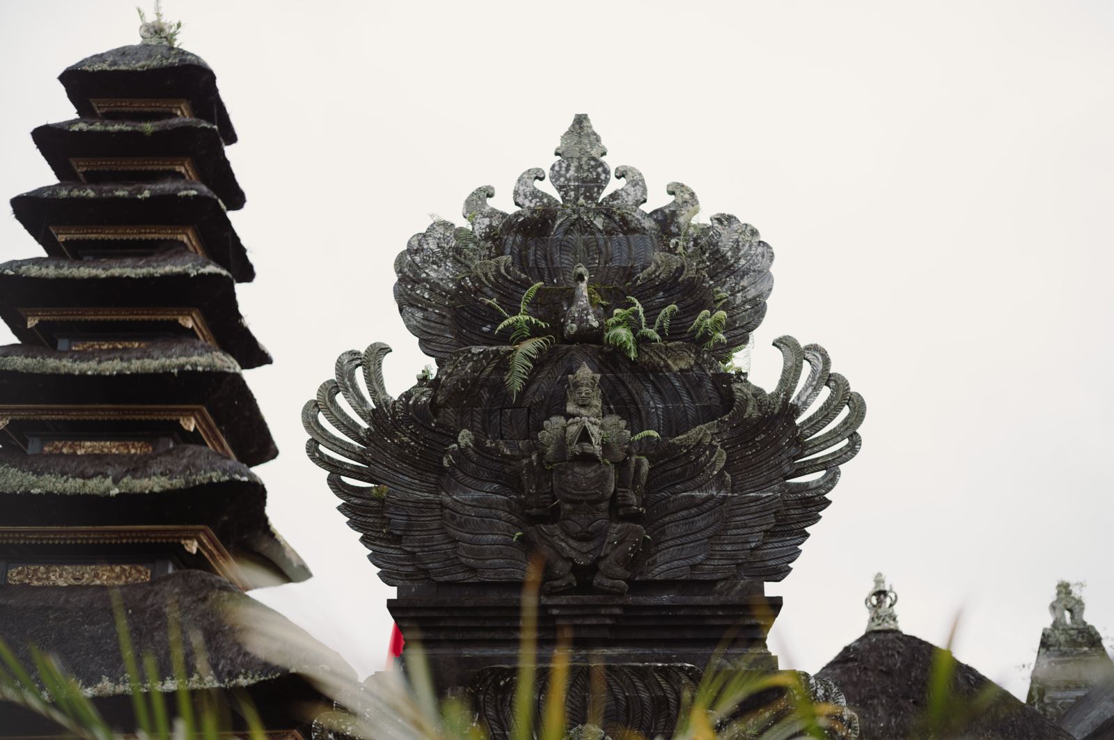 Traditional Balinese temple towers and carved stone gate